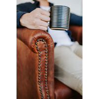 detail shot of a custom lounge chair with nail head trim on the arm