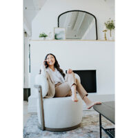 a custom white swivel chair with a woman taking a call in it