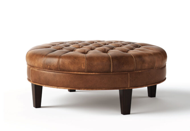Round Cambridge tufted ottoman from Vogel by Chervin in brown leather and espresso legs with a hand-tufted top
