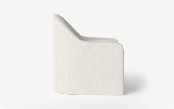 Side view of curved silhouette of the Amelia upholstered dining chair by Vogel. Made in Toronto, Ontario.