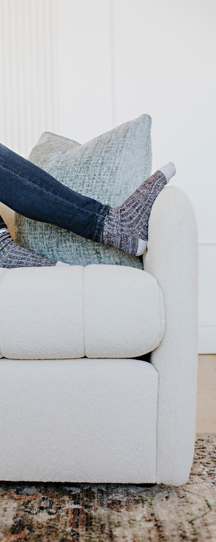 a detail shot of a sofa arm on a custom channel tufted sofa