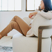 woman taking a work call in a custom Canadian made Zara swivel chair