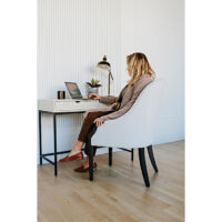 woman working at a desk in a white custom accent chair