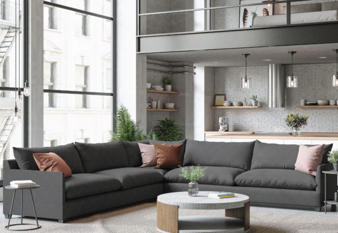 Bright studio apartment with large windows and large charcoal L-shaped sectional