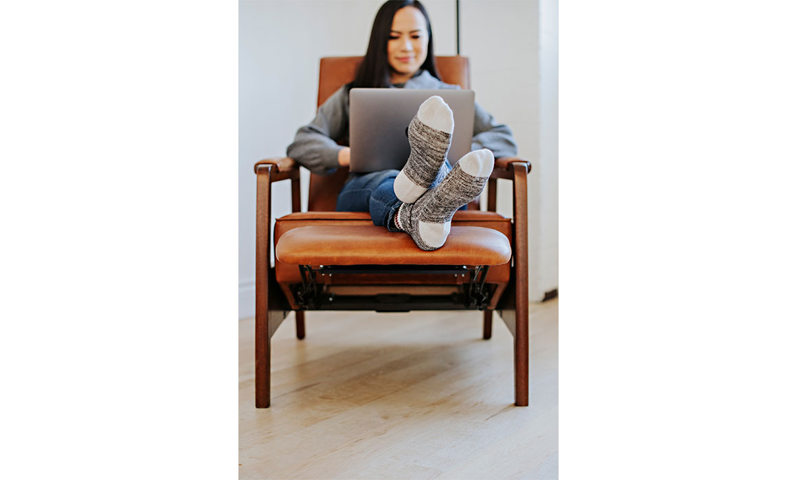woman with her feet up in a custom brown leather recliner