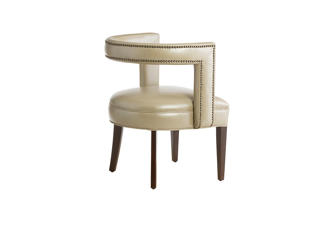 Rear view of a beige leather contemporary accent chair featuring nailhead trims, flared legs, and espresso wood finish