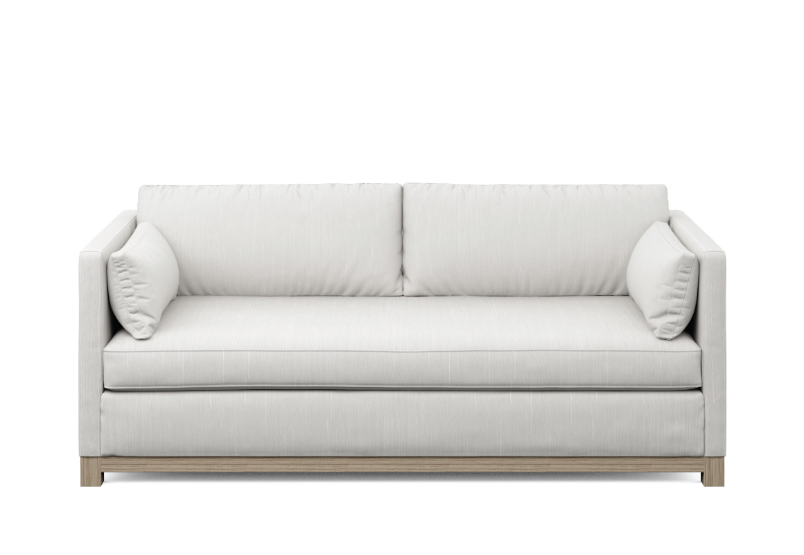 modern white condo sofa with wood base and two pillows