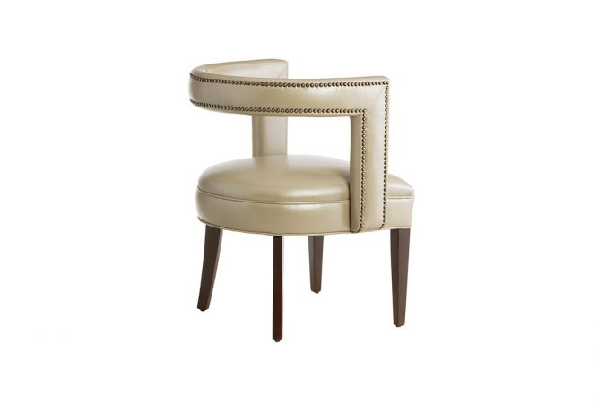 Rear view of a beige leather contemporary accent chair featuring nailhead trims, flared legs, and espresso wood finish