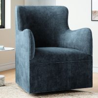 A sleek, modern dark blue velvet swivel chair in a calming living room
