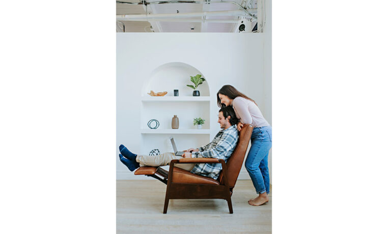 woman looking over mans shoulder in a custom leather recliner