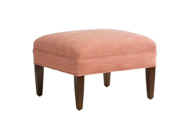 Angled shot of classic Stirling Ottoman by Vogel with red fabric and brown wood finish