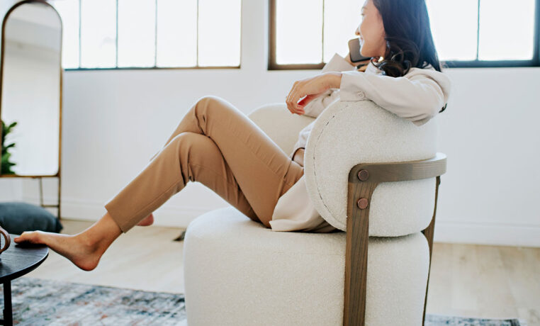 woman taking a work call in a custom Canadian made Zara swivel chair
