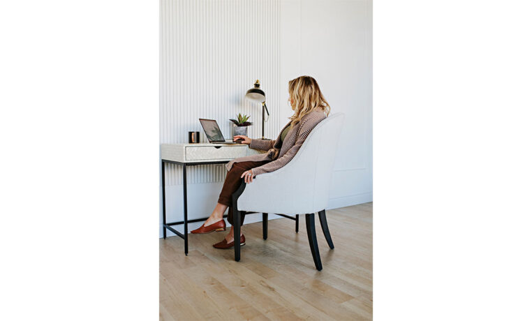 woman working at a desk in a white custom accent chair