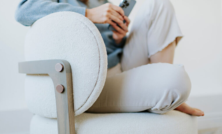a detail shot of a custom white accent chair with curved back