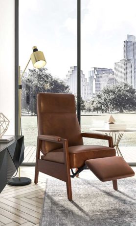 The Oxford leather reclining chair by Vogel styled against bright window.