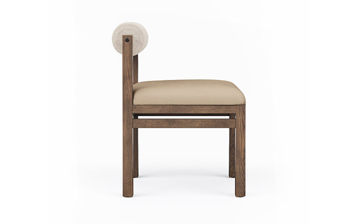 Side view of the Marlowe dining Chair with a bolstered back.