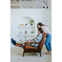 woman looking over mans shoulder in a custom leather recliner