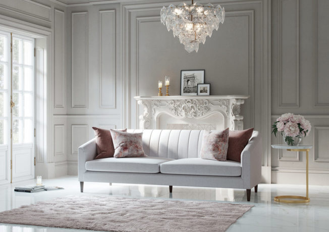 Mid century modern channel tufted grey sofa with tapered legs styled in elegant Madison room.