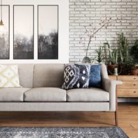 Bright modern room with beige mid century modern sofa as focal point