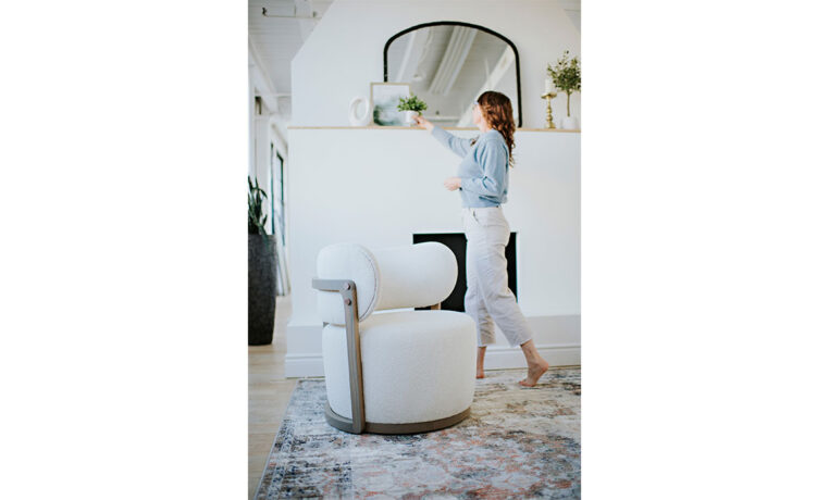 a white accent chair in a white living room