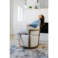a woman twirling in a custom white swivel chair