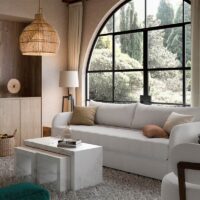 valentino modern channel tufted sofa in a living room with a fireplace