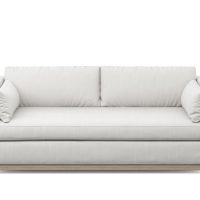 modern white condo sofa with wood base and two pillows
