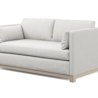 white modern loveseat with oak wood base side view
