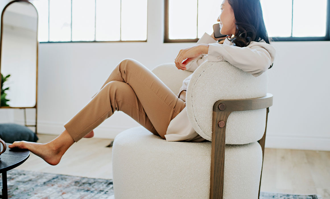 woman taking a work call in a custom Canadian made Zara swivel chair