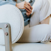 a detail shot of a custom white accent chair with curved back